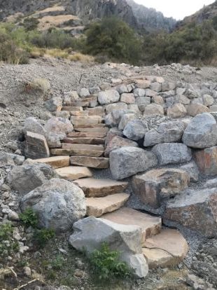 A staircase down a rocky mountainside made from natural stone